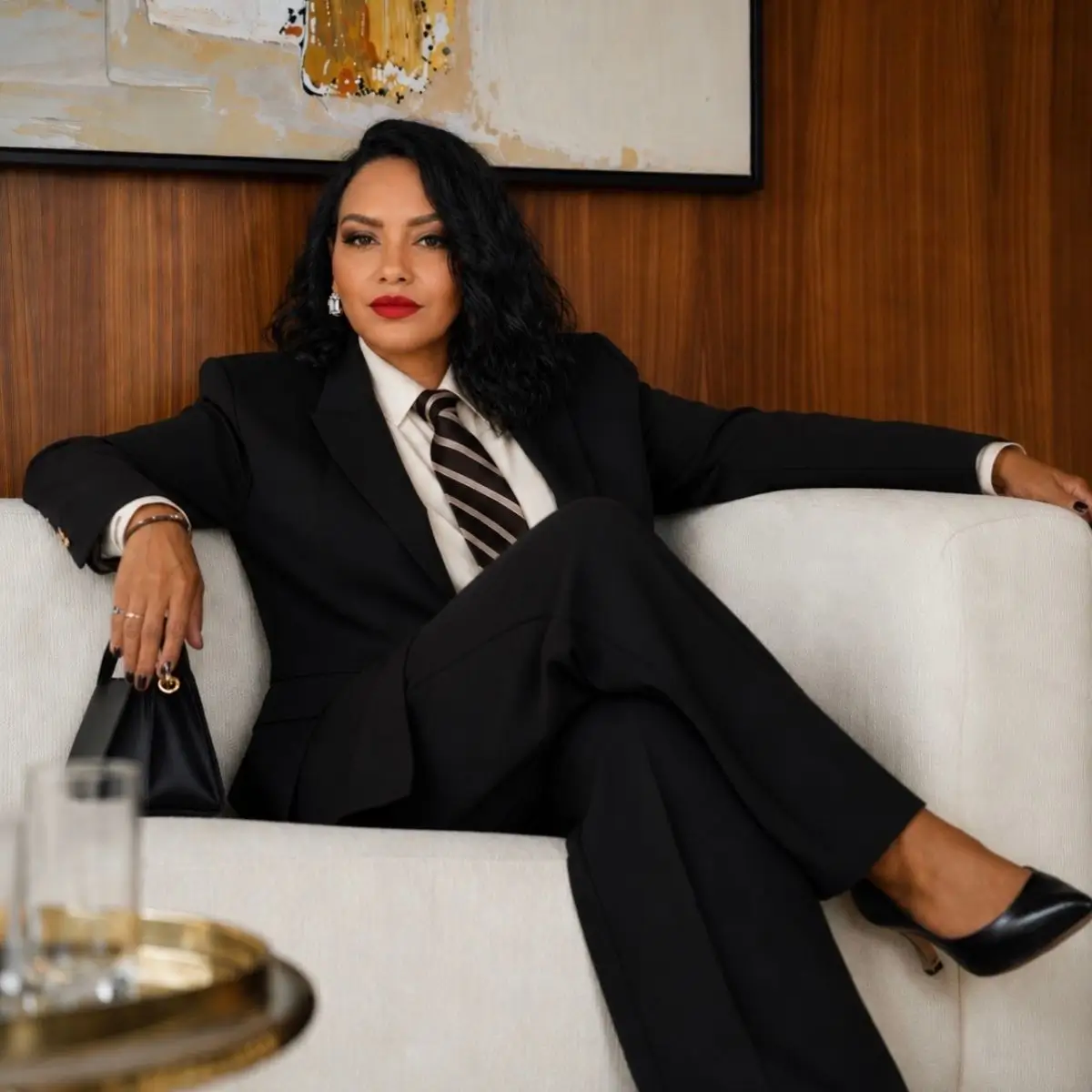 Leah Carter sitting in an office, representing a successful woman entrepreneur using AI to build and scale a profitable business.